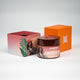 Orange Butter Me Up shea body butter with white text and girl illustration, nourishing body care essential.