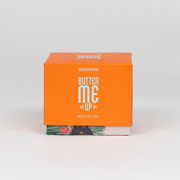 Square orange Butter Me Up shea body butter with bold white product name, perfect for deep body hydration.