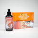 Shower gel bottle with focus on orange product package lying in the background, refreshing body care essentials.