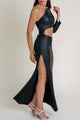 Full-body side view of the Pearl of the Orient black dress styled with strappy heels.