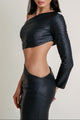 Side view of model wearing a textured black cut-out dress with one-sleeve design and sculpted silhouette.
