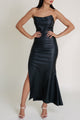 Woman wearing Macao Casino black dress with a side cutout and white heels from the Macao collection.