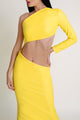 Woman posing and wearing a yellow Casa di Campara one-shoulder dress with cut-out design.