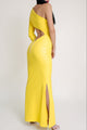 Back view of a yellow one-sleeve cut-out gown with side slit and exposed zipper detail.