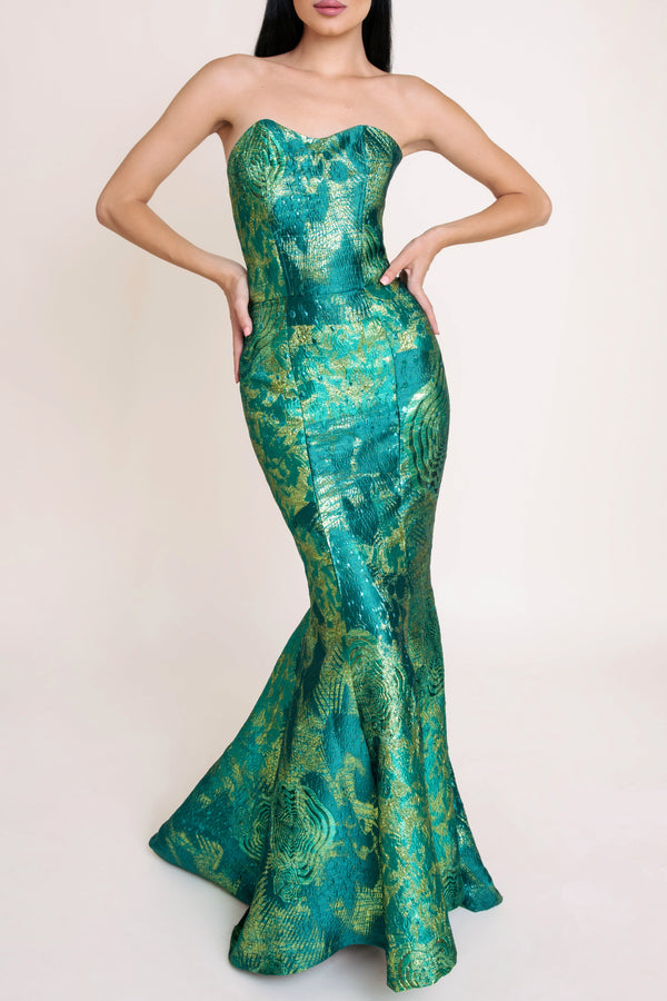 Woman in elegant emerald green dress with gold details from Casa Di Campara Macao collection.