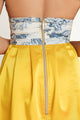 Back close-up of two tone summer mini dress with printed white top and pleated yellow skirt - lemonade dress perfect for sunny vacations.