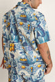 Relaxed-fit unisex zip-up shirt with intricate blue-and-white tile print and gold zipper.