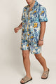 Man in Algarve Coast Casa Di Campara shirt with gold zipper and blue-white print.