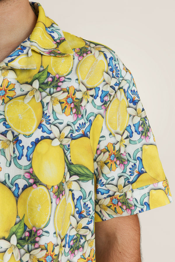 Close-up of lemon-and-leaf printed summer shirt - unisex shirt in bright citrus hues, ideal for beach days or layering over swimwear.