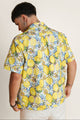 Back view of lemon-print summer shirt - unisex zip-up shirt in citrus tones, great for pairing with summer shorts.