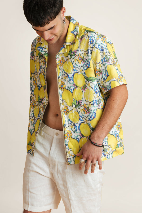 Model wearing a vibrant lemon-print summer shirt - lightweight crop-style top perfect with summer shorts for sunny escapes.