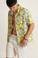 Model wearing a vibrant lemon-print summer shirt - lightweight crop-style top perfect with summer shorts for sunny escapes.
