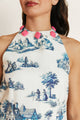 Close-up of the Lagos Azure cotton dress, highlighting the white fabric, blue print, and pink detailing around the neckline.