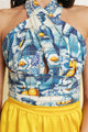 Close up of a yellow summer mini dress with a printed top, perfect for beach days or vacation.
