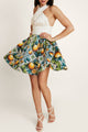 Woman in Faro Lemonade summer dress by Casa Di Campara, white cotton top and vegan silk lemon-print skirt.