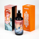 The focus is on a massage oil bottle with a pump, with the orange cap and the lower part of the box featuring a mermaid design visible in the background.