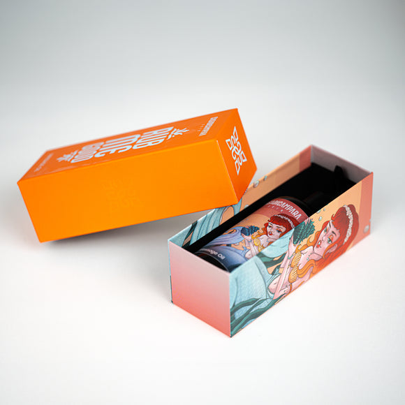Rub Me Good massage oil bottle with pump inside long orange Casa Di Campara box featuring matching mermaid print.