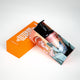 Rub Me Good massage oil bottle at the bottom of the mermaid package resting on an orange lid, highlighting skincare essentials.