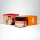 Round body scrub with orange lid and beachwear girl illustration, perfect for refreshing and exfoliating body care.