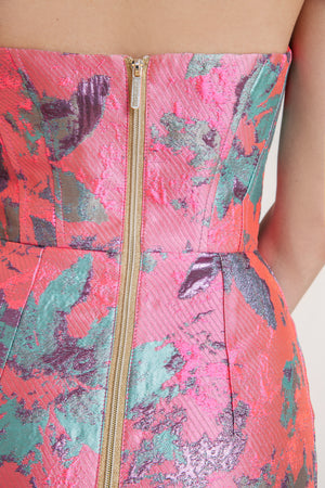 Close-up of jacquard fabric in baby pink showcasing an intricate, luxurious texture that elevates this elegant summer dress