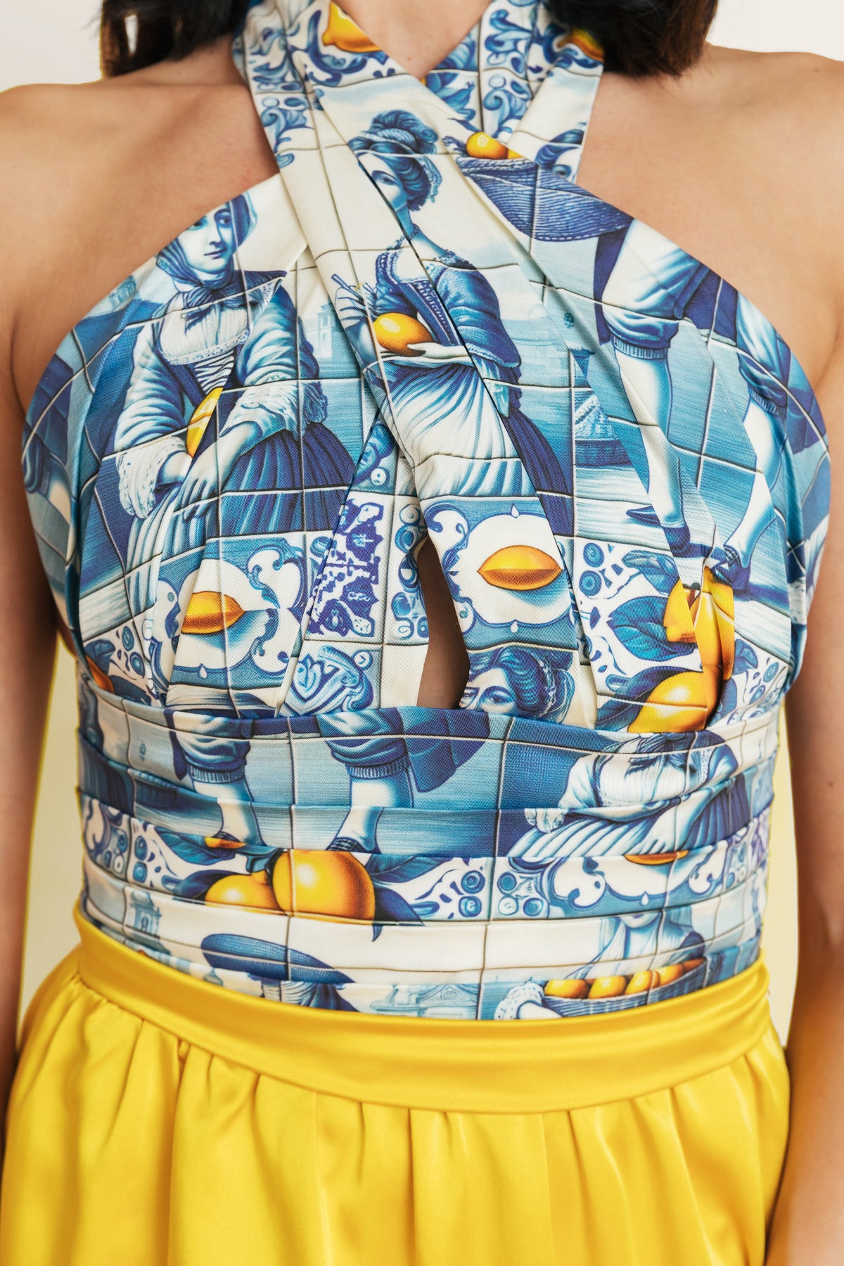 Close up of a yellow summer mini dress with a printed top, perfect for beach days or vacation.